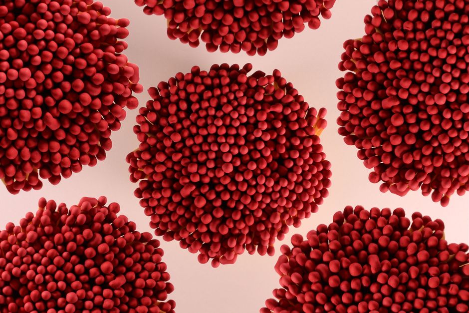 Top view of heaps of wooden matches with red heads arranged together in shape of sphere