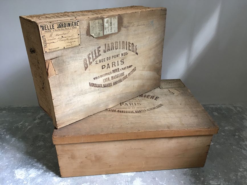 Rustic wooden boxes with aged French labels, showcasing a vintage aesthetic.